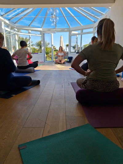 Ylva leading a breathwork class in the conservatory