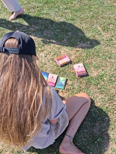 A guest choosing oracle cards on the grass