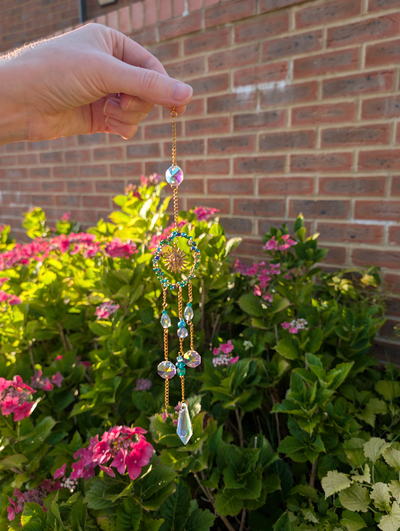 A beaded sun catcher with a golden sun charm