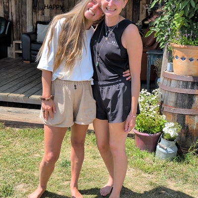 Two of the hosts embracing outdoors